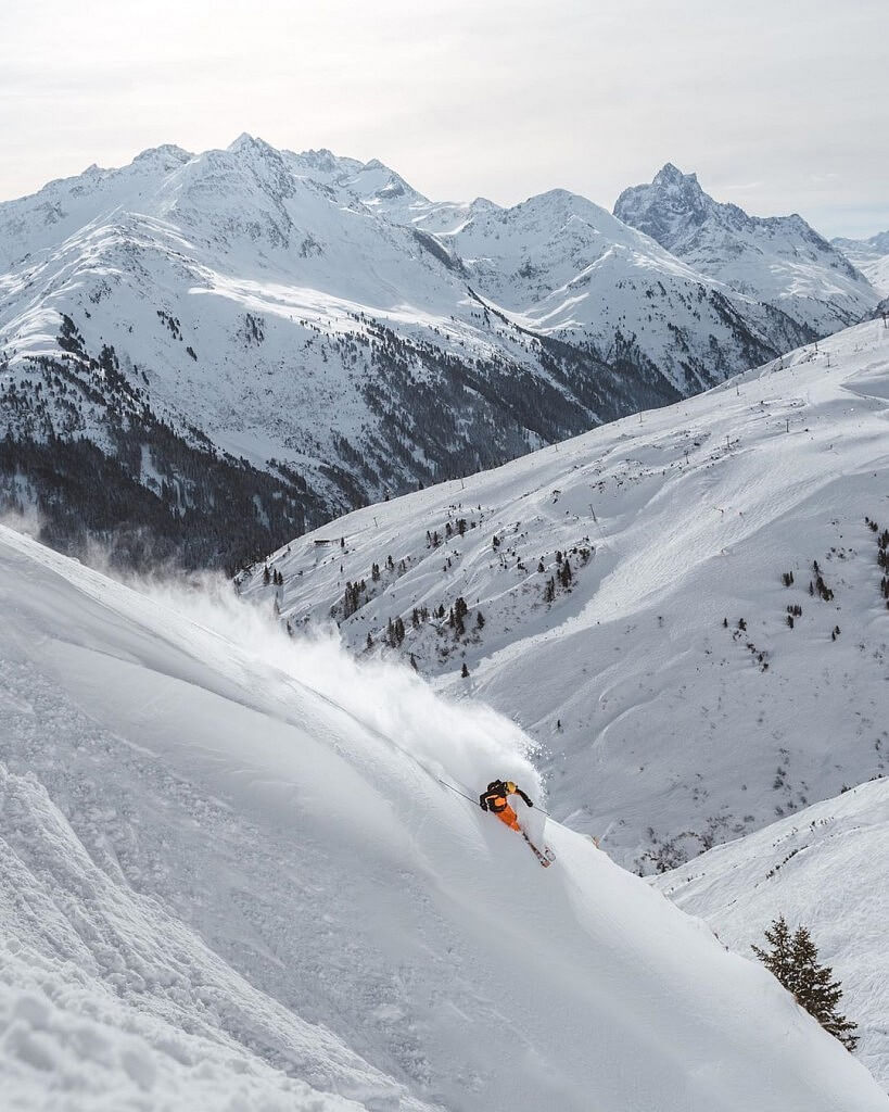 Skiing down the slope in St. Anton Alps