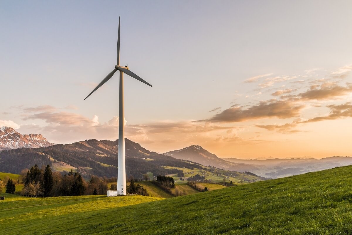 windmill in a green field producing alternative-energy