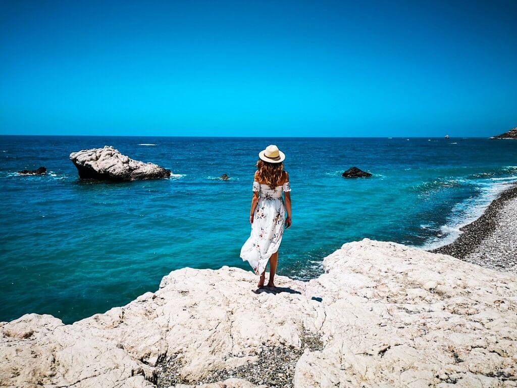 Girls standing on the Aphrodite's Rock in Cyprus