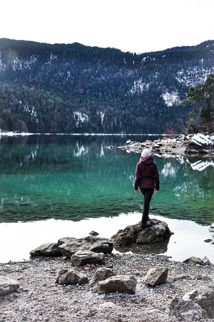 A girl standing on the shores of lake Eibsee