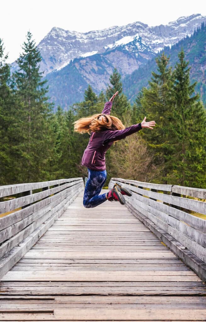 Girl jumping in the nature in beautiful lanscape