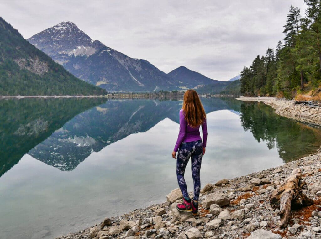 Hiking in the alps with the view over alpine lake