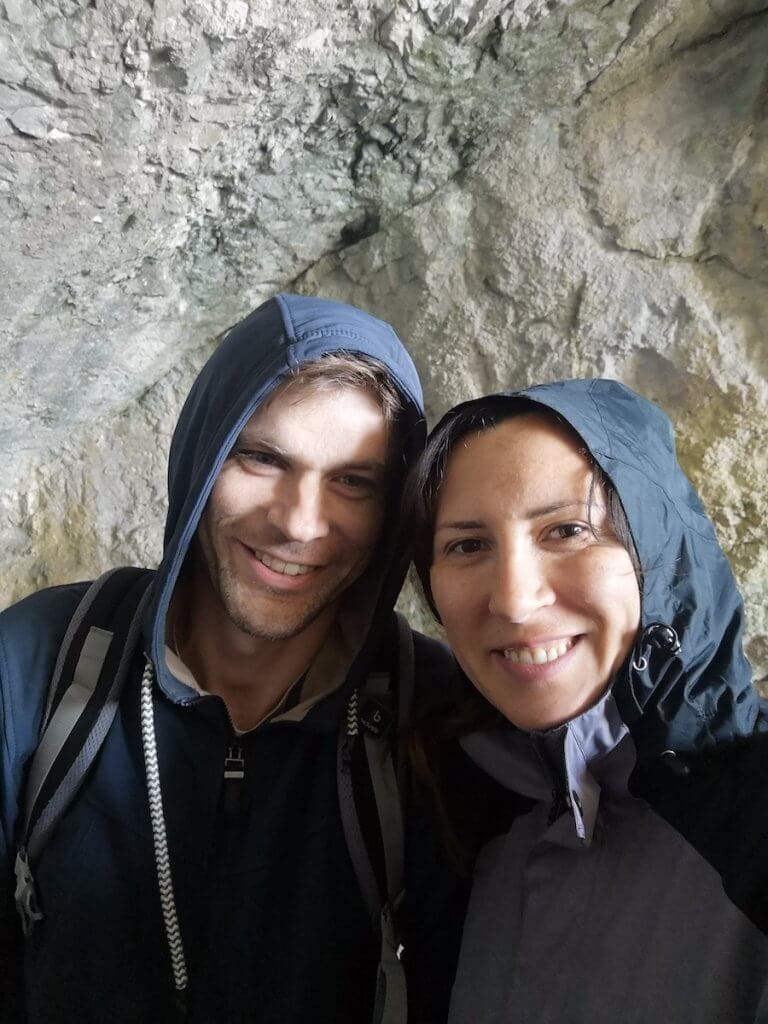 two people wearing warm clothes at the  entrance to eisriesenwelt ice caves